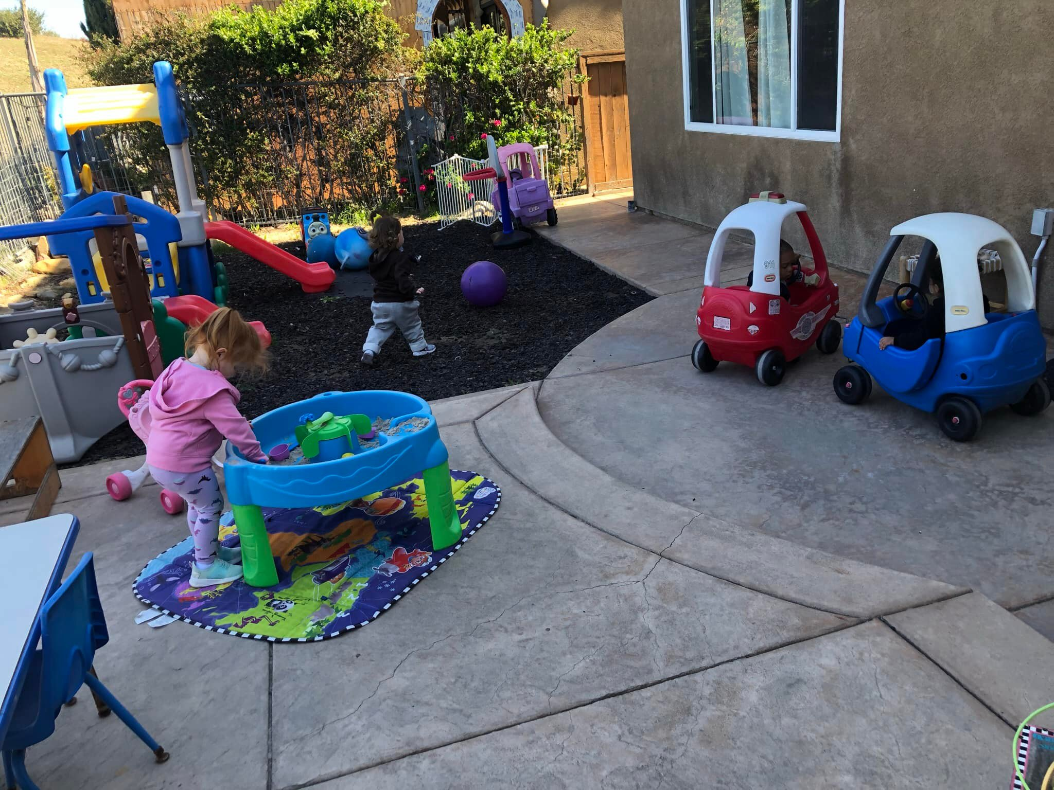 Spacious outdoor play area with water table and toys
